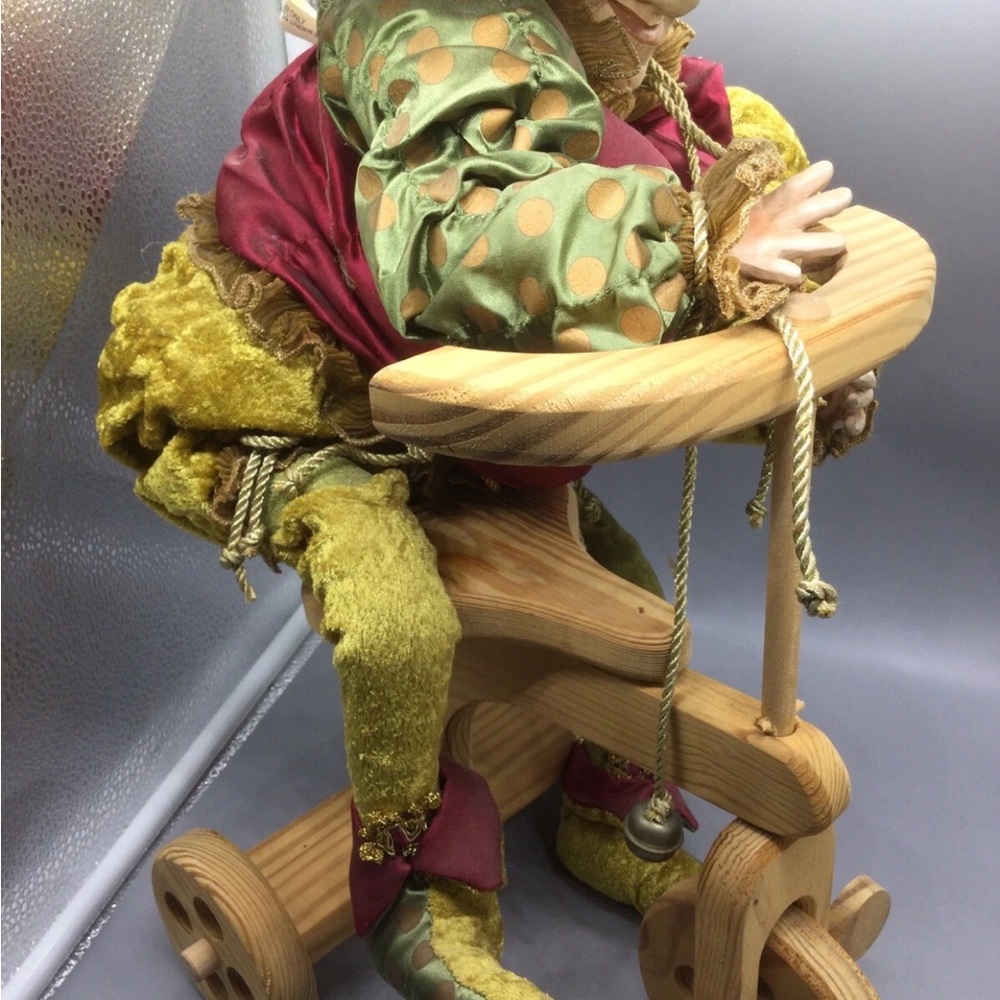 Colorful Jester Doll on Wooden Scooter